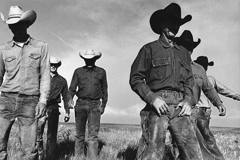 Cowboys walking together across open country in Shackelford County, Texas.